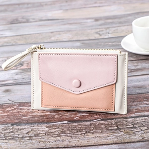 Three-tone color block women's mini wallet on rustic wood table with soft lighting