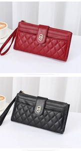 Detail of red and black quilted leather wallets with gold hardware and wristlet straps