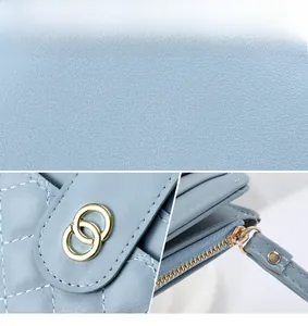 Detail view of light blue quilted leather wallet with gold hardware and internal card slots