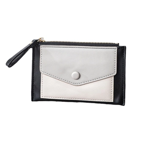 Detail of color-block slim wallet showing top metal zipper and front envelope snap pocket