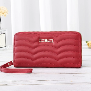 Red long wallet for women featuring wave quilting and golden bow metallic ornament