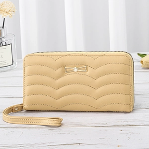 Elegant beige quilted long wallet for women with gold bow detail and wristlet strap