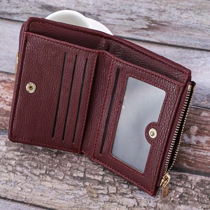 Detailed interior of wine red leather short wallet showing card slots and zip coin pocket