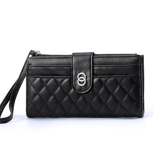 Women's black quilted clutch wallet with gold ring hardware and wristlet strap