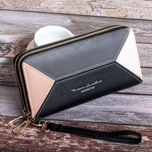Detail of multi-color block long wallet featuring double zippers and detachable wrist strap