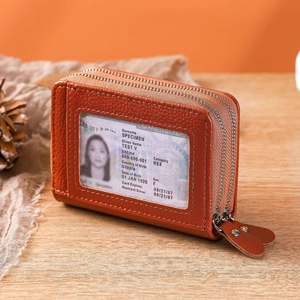 Brown leather double zipper accordion card wallet with RFID protection on a wooden desk