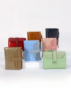 Close-up of stone pattern texture on multiple colorful leather wallets with zippers