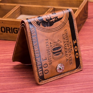 Detailed close-up of brown vintage bi-fold wallet with 100 dollar bill pattern and snap button