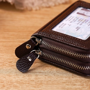 Detail of RFID leather card holder with dual zippers and transparent ID window