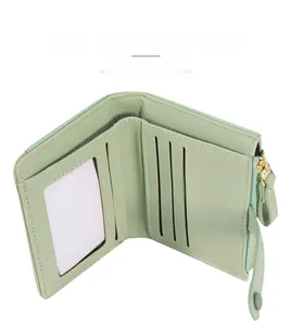 Detail view of mint green wallet interior featuring multiple card slots and a zipper pocket