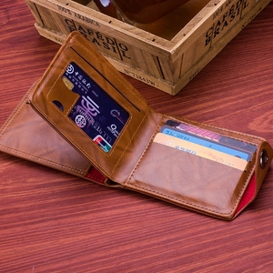 Detailed interior of brown leather wallet featuring card slots and snap button closure