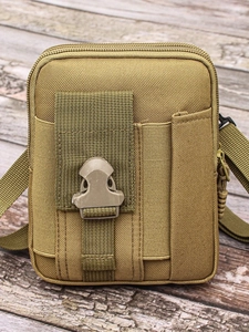Tactical nylon waist bag for men in khaki desert color on a vintage wood background