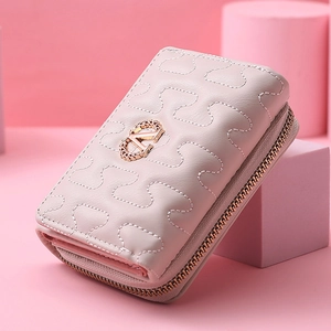 Detail of light pink faux leather wallet with S-quilted texture and golden V logo