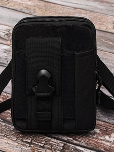 Tactical black nylon waist bag with double zippers and buckle closure on wood background