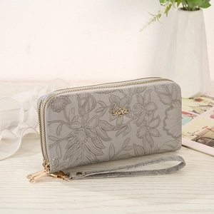 Close-up of gray long wallet for women with flower embossing and golden bow hardware