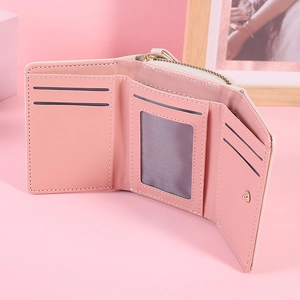 Detail view of pink trifold wallet interior with card slots and zipper coin pocket