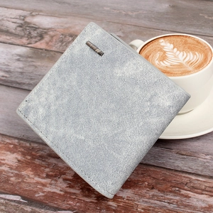 Close-up of grey denim texture and metal logo detail on men's bi-fold wallet