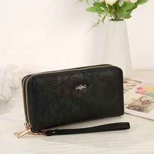 Macro view of black PU long wallet with floral embossing and gold double zippers