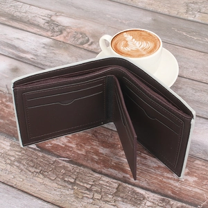 Close-up of brown denim wallet with multi-card slots on a rustic wooden table
