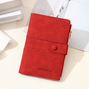 Detail of red RFID passport wallet with zipper, snap closure, and textured finish
