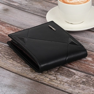 Close-up of black leather wallet with geometric stitching and metal logo on wood