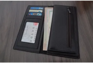 Detail view of the black leather wallet interior showing card slots and zipper pocket
