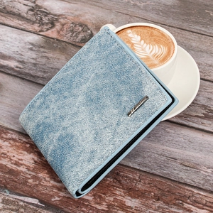 Short denim men's wallet in light blue with texture detail on a rustic wooden table