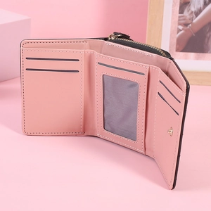 Pink trifold wallet detail showing five card slots, photo window and a zipper pocket
