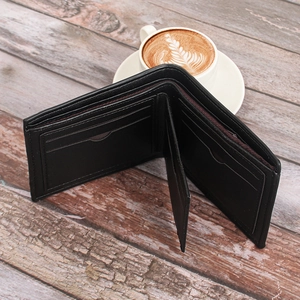 Interior detail of black leather men wallet showing card slots and brown lining texture