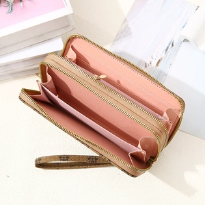 Detailed interior of vintage brown patterned long wallet with pink card slots and double zippers