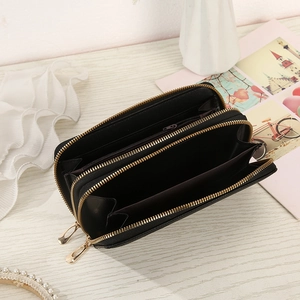 Internal view of black dual-zipper long wallet with multiple card slots and cash sections
