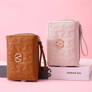 Detail of quilted leather mini wallets with S-stitch embroidery and metal V logo