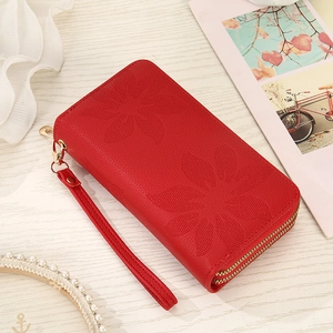 Detail of red embossed floral long wallet with double zippers and wrist strap