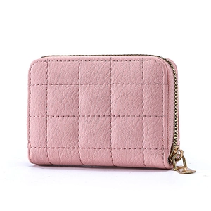 Detail of pink quilted leather card holder with diamond stitching and gold metal zipper