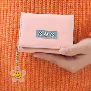 Detail of pink PU leather short wallet with sunflower pendant and flower patch