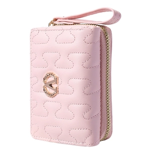 Close-up of pink quilted trifold wallet with golden V logo and wrist strap detail