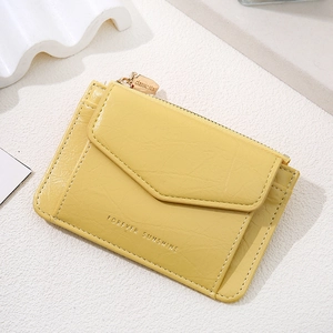 Detail of yellow pebbled leather wallet with envelope flap and Forever Sunshine text