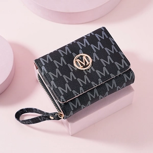 Fashionable black trifold wallet with M-letter pattern and gold metal logo on pink stand