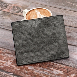 Close-up of a dark grey bi-fold wallet with Saffiano texture on a wooden desk
