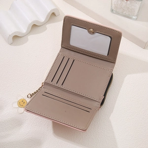 Detail view of pink bicolor short wallet featuring multiple card slots and gold zipper