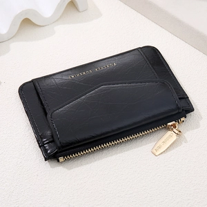 Detail of black faux leather card holder with gold zipper and Forever Sunshine text