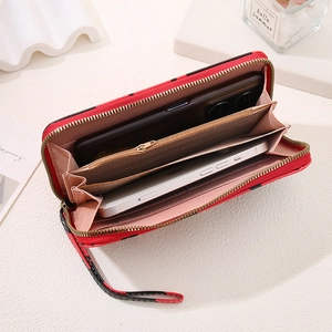 Macro view of cow print wallet interior with multiple card slots and dual phone compartments