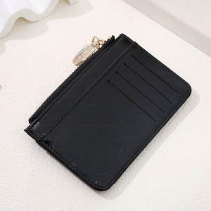 Close-up of black embossed leather wallet with multiple card slots and gold zipper