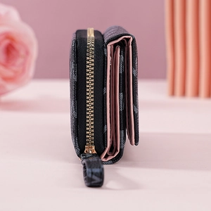 Detail view of the black letter-printed trifold wallet with a secure gold-tone zipper