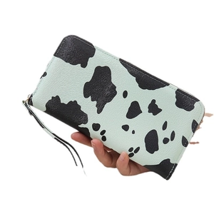 Long mint green cow print wallet with zipper closure and wristlet for women