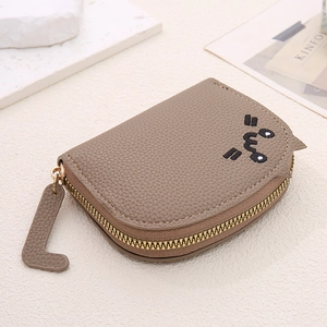 Detail of taupe cat-themed wallet with leather texture and cute facial embroidery