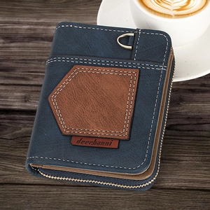 Detail of blue and brown leather wallet with metal D-ring on dark wooden surface
