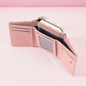 Interior view of light pink tri-fold wallet showing multiple card slots and bill compartment