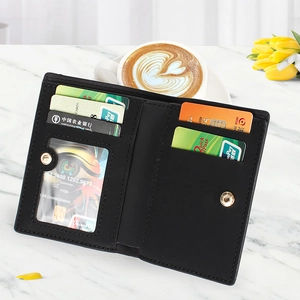 Close-up of black leather bi-fold wallet interior featuring multiple card slots and photo ID window
