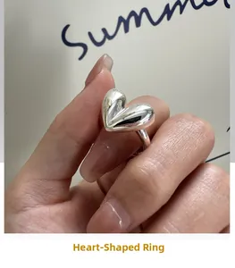 Macro detail of polished S925 sterling silver heart ring with engraved hallmark